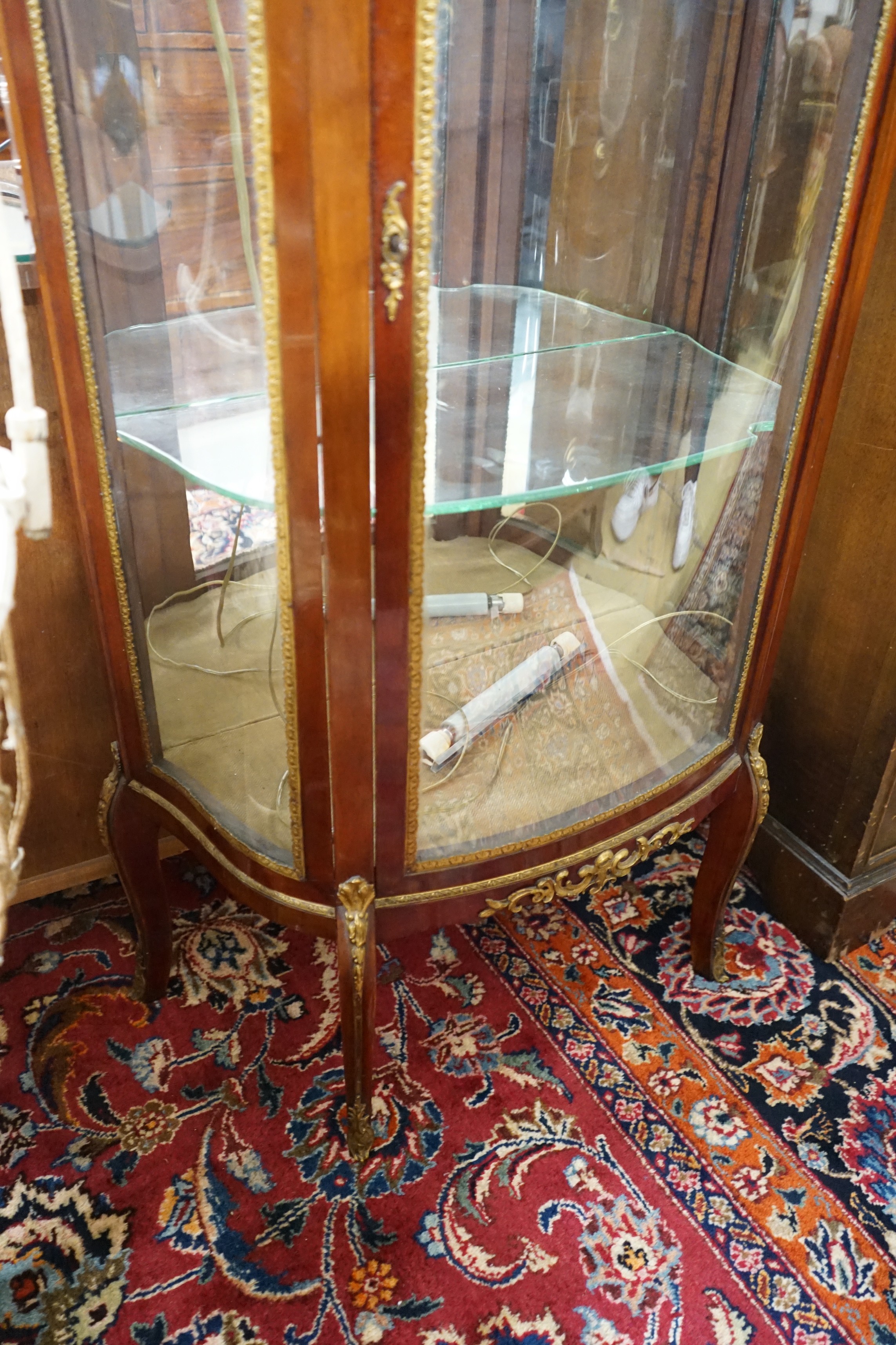 A Louis XV style gilt metal mounted marble topped bow fronted vitrine, width 67cm, depth 34cm, height 139cm